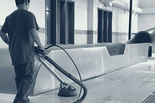 Technician cleaning a hard surface with a rotary tool